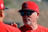 Los Angeles Angels manager Joe Maddon talks with a player during spring training baseball practice, Monday, Feb. 17, 2020, in Tempe, Ariz. (AP Photo/Darron Cummings)