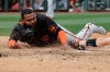San Francisco Giants' Pablo Sandoval slides safe into home ahead of the tag from Arizona Diamondbacks' John Hicks during the fifth inning of a spring training baseball game, Monday, March 2, 2020, in Scottsdale, Ariz.(AP Photo/Darron Cummings)