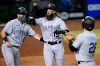 Colorado Rockies' Charlie Blackmon celebrates his grand slam with Drew Butera, left, and Nolan Arenado (28) during the eighth inning of a baseball game against the Arizona Diamondbacks, Wednesday, Aug. 26, 2020, in Phoenix. (AP Photo/Matt York)