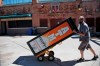 Mike Durkin, of Eclipse Cash Systems/Payment Alliance International, removes ATMs from Scottsdale Stadium, the spring training home of the San Francisco Giants, in Scottsdale, Ariz., Saturday, March 14, 2020. The remainder of spring training baseball games have been canceled due to the coronavirus outbreak. (AP Photo/Sue Ogrocki)