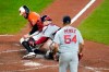 Baltimore Orioles' Renato Nunez, left, is tagged out at home by Boston Red Sox catcher Christian Vazquez, center, as starting pitcher Martin Perez (54) looks on during the fourth inning of a baseball game, Saturday, Aug. 22, 2020, in Baltimore. Nunez tried to score from second base on a hit by Pat Valaika. (AP Photo/Julio Cortez)