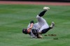 New York Yankees center fielder Brett Gardner tumbles after he made a sliding catch on a line drive by Baltimore Orioles' Anthony Santander for the out during the fifth inning of the first baseball game of a doubleheader, Friday, Sept. 4, 2020, in Baltimore. The Yankees won 6-5 in nine innings. (AP Photo/Nick Wass)