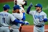 Los Angeles Dodgers' Max Muncy, right, celebrates with Justin Turner, second from left, and A.J. Pollock, left, after hitting a three-run home run off San Francisco Giants' Johnny Cueto in the first inning of a baseball game Tuesday, Aug. 25, 2020, in San Francisco. (AP Photo/Ben Margot)