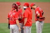 Los Angeles Angels pitcher Andrew Heaney, second from left, speaks with pitching coach Mickey Callaway, second from right, in the first inning of a baseball game against the Oakland Athletics Friday, Aug. 21, 2020, in Oakland, Calif. (AP Photo/Ben Margot)