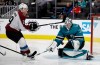 Colorado Avalanche center Nathan MacKinnon, left, shoots against San Jose Sharks goalie Martin Jones during the second period of an NHL hockey game Sunday, March 8, 2020, in San Jose, Calif. (AP Photo/Ben Margot)