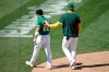Oakland Athletics' Ramon Laureano is walked off the field after charging the Houston Astros dugout after being hit by a pitch thrown by Humberto Castellanos in the seventh inning of a baseball game Sunday, Aug. 9, 2020, in Oakland, Calif. (AP Photo/Ben Margot)