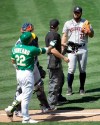 Oakland Athletics' Ramon Laureano (22) gestures to Houston Astros pitcher Humberto Castellanos, right, after being hit by a pitch thrown by Castellanos in the seventh inning of a baseball game Sunday, Aug. 9, 2020, in Oakland, Calif. (AP Photo/Ben Margot)