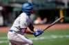 Texas Rangers' Willie Calhoun swings for an RBI sacrifice fly against the San Francisco Giants during the seventh inning of a baseball game Sunday, Aug. 2, 2020, in San Francisco. (AP Photo/Ben Margot)