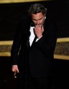 Joaquin Phoenix reacts as he accepts the award for best performance by an actor in a leading role for 