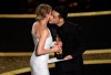 Renee Zellweger, left, accepts the award for best performance by an actress in a leading role for 