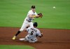 San Diego Padres' Jake Cronenworth, top, turns a double play as Arizona Diamondbacks' David Peralta (6) attempts to break up the play in the sixth inning of a baseball game Saturday, Aug. 8, 2020, in San Diego. Diamondbacks' Eduardo Escobar was out at first base. (AP Photo/Derrick Tuskan)