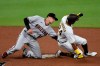 Arizona Diamondbacks shortstop Nick Ahmed, left, tags out San Diego Padres' Edward Olivares as Olivares attemps to steal second base during the sixth inning of a baseball game in San Diego, Saturday, July 25, 2020. (AP Photo/Kelvin Kuo)