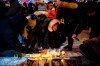 Mourners place candles and photographs during a vigil for those who were among the 176 people who were killed when Ukraine International Airlines Flight PS752 crashed after takeoff near Tehran, Iran, outside the Alberta Legislature Building in Edmonton on Wednesday, Jan. 8, 2020. THE CANADIAN PRESS/Codie McLachlan