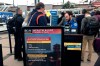 FILE - In this Monday, March 2, 2020 file photo, a health alert for people traveling to China is shown at a TSA security checkpoint at the Denver International Airport in Denver. A steep drop in business travel could be a gut punch to a tourism industry already reeling from the coronavirus outbreak, as big companies like Amazon try to keep employees healthy by banning trips. (AP Photo/Charles Rex Arbogast, File)