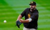 Newly-acquired San Diego Padres first baseman Mitch Morteland warms up before a baseball game against the Colorado Rockies, Monday, Aug. 31, 2020, in Denver. Moreland comes to San Diego from the Boston Red Sox. (AP Photo/David Zalubowski)