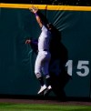 Colorado Rockies center fielder Kevin Pillar runs into the wall as he pulls in a fly ball off the bat of San Francisco Giants' Evan Longoria for the third out in the top of the seventh inning of a baseball game Wednesday, Sept. 2, 2020, in Denver. (AP Photo/David Zalubowski)