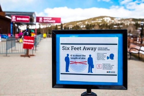 A sign near the Breckenridge Ski Resort gondola in Breckenridge, Colo., Saturday, March 14, 2020, outlines public health guidelines about social distancing to limit the spread of the new coronavirus. Signs with public health guidelines about social distancing to limit the spread of the new coronavirus were posted around the resort, and later in the day, Vail Resorts announced it would close all of its ski areas in North America through March 22, including Breckenridge and Keystone Resort in Summit County. (Liz Copan/Summit Daily News via AP)