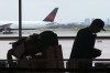 A passenger waits beside their luggage at the departure terminal at Toronto Pearson Airport, in Mississauga, Ont., Friday, May 24, 2019. Air Canada says it is cancelling select flights to China as passengers shaken by the coronavirus epidemic delay or call off travel plans. THE CANADIAN PRESS/Chris Young