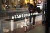 The front window of a downtown Starbucks Coffee store is shown in Toronto, May 10, 2018. Starbucks is stopping the use of reuseable cups and is halting business travel to combat the spread of the novel coronavirus. THE CANADIAN PRESS/Graeme Roy