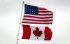 U.S. and Canadian flags fly in Point Roberts, Wash., on Tuesday March 13, 2012. President Donald Trump is confirming that the Canada-U.S. border will be closed 