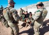 In this Feb. 20, 2017 file photo, Canadian special forces soldiers, left and right, speak with Kurdish Peshmerga fighters at an observation post, in northern Iraq. Federal opposition parties are divided over whether Canada should press ahead with its five-year-old mission in Iraq or start bringing home its soldiers, some of whom were forced to take cover last week from Iranian ballistic missiles. THE CANADIAN PRESS/Ryan Remiorz