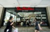 People walk past the newly renovated Tim Hortons in Toronto on Thursday, July 25, 2019. THE CANADIAN PRESS/Nathan Denette