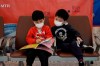 Passengers wear masks to prevent an outbreak of a new coronavirus in the high speed train station, in Hong Kong, Wednesday, Jan. 22, 2020. THE CANADIAN PRESS/AP/Kin Cheung