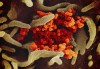 This undated electron microscope image made available by the U.S. National Institutes of Health in February 2020 shows the Novel Coronavirus SARS-CoV-2, orange, emerging from the surface of cells, green, cultured in the lab. THE CANADIAN PRESS/HO - NIAID-RML via AP