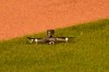 A drone lies on the grass after it landed in center field, before taking off again and flying out of the stadium, during the fifth inning of a baseball game between the Chicago Cubs and the Cleveland Indians on Wednesday, Sept. 16, 2020, in Chicago. Play was briefly suspended. (AP Photo/Mark Black)