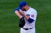 Chicago Cubs starting pitcher Jon Lester wipes his face during the first inning of a baseball game against the St. Louis Cardinals in Chicago, Sunday, Sept. 6, 2020. (AP Photo/Nam Y. Huh)