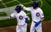 Chicago Cubs' Kris Bryant, right, pats Willson Contreras, left, on the helmet after Contreras drove in Bryant on a RBI sacrifice fly against the Cleveland Indians during the seventh inning of a baseball game, Tuesday, Sept.15, 2020, in Chicago. (AP Photo/David Banks)
