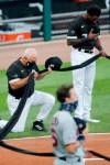 Chicago White Sox manager Ricky Renteria kneels for social justice next to Tim Anderson before a baseball game against the Minnesota Twins, Friday, July 24, 2020, in Chicago. (AP Photo/Charles Rex Arbogast)