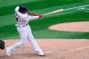Chicago White Sox's Eloy Jimenez hits an RBI double off Minnesota Twins relief pitcher Sergio Romo during the seventh inning of a baseball gamem Thursday, Sept. 17, 2020, in Chicago. Yolmer Sanchez scored on the play. (AP Photo/Charles Rex Arbogast)