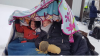 Canduce Tokash, left, and her friend Barbie Hudson huddle under blankets outside the Whitemouth Community Club at 9 a.m. Saturday. (Submitted to CBC)