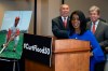 Rep. William Lacy Clay, D-Mo., left, and Sen. Roy Blunt, R-Mo., right, stand as Judy Pace Flood speaks during a news conference as they call for the late Curt Flood to be inducted into the Baseball Hall of Fame, on Capitol Hill, Thursday, Feb. 27, 2020 in Washington. (AP Photo/Alex Brandon)