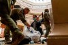 Rep. Andy Kim, D-N.J., helps ATF police officers clean up debris and personal belongings strewn across the floor of the Rotunda in the early morning hours of Thursday, Jan. 7, 2021, after protesters stormed the Capitol in Washington, on Wednesday. (AP Photo/Andrew Harnik)