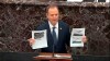 In this image from video, House impeachment manager Rep. Adam Schiff, D-Calif., holds redacted documents as he speaks during the impeachment trial against President Donald Trump in the Senate at the U.S. Capitol in Washington, Wednesday, Jan. 22, 2020. (Senate Television via AP)