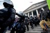 Police in riot gear walk out of the Capitol, Wednesday, Jan. 6, 2021, in Washington. As Congress prepares to affirm President-elect Joe Biden's victory, thousands of people have gathered to show their support for President Donald Trump and his claims of election fraud. (AP Photo/Manuel Balce Ceneta)