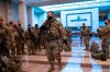 Hundreds of National Guard troops hold inside the Capitol Visitor's Center to reinforce security at the Capitol in Washington, Wednesday, Jan. 13, 2021. The House of Representatives is pursuing an article of impeachment against President Donald Trump for his role in inciting an angry mob to storm the Capitol last week. (AP Photo/J. Scott Applewhite)