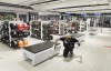 Liam Slater Oda, an employee with Sports Experts disenfects a bench at the store on Sainte-Catherine street in Montreal, Sunday May 24, 2020. THE CANADIAN PRESS/Graham Hughes