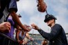 New York Yankees manager Aaron Boone signs autographs during a spring training baseball workout Thursday, Feb. 13, 2020, in Tampa, Fla. (AP Photo/Frank Franklin II)