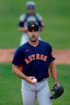 Houston Astros pitcher Justin Verlander warms up prior to a spring training baseball game against the St. Louis Cardinals, Tuesday, March 3, 2020, in Jupiter, Fla. (AP Photo/Julio Cortez)