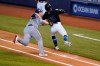 Tampa Bay Rays first baseman Ji-Man Choi, left, tags out Miami Marlins' Jon Berti along the first-base line during the first inning of a baseball game, Saturday, Aug. 29, 2020, in Miami. (AP Photo/Wilfredo Lee)