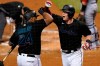 Miami Marlins' Garrett Cooper, right, celebrates with Jesus Aguilar (24) after hitting a two-run home run during the third inning of the team's baseball game against the Washington Nationals, Saturday, Sept. 19, 2020, in Miami. (AP Photo/Lynne Sladky)