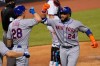 New York Mets' Robinson Cano (24) bumps elbows with J.D. Davis (28) after they scored on a two-run home run by Cano during the third inning of a baseball game against the Miami Marlins, Monday, Aug. 17, 2020, in Miami. (AP Photo/Lynne Sladky)
