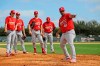 St. Louis Cardinals pitchers listen as coach Dernier Orozco (41) instructs them on covering home plate during spring training baseball practice Sunday, Feb. 16, 2020, in Jupiter, Fla. (AP Photo/Jeff Roberson)
