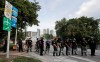 A line of City of Miami police officers block a ramp for Interstate 95 as protesters march against the death of George Floyd, Sunday, May 31, 2020, in Miami. Floyd died after being restrained by Minneapolis police officers on May 25. (AP Photo/Wilfredo Lee)