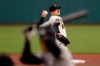San Francisco Giants' Drew Smyly, rear, pitches against Colorado Rockies' Raimel Tapia during the first inning of a baseball game in San Francisco, Tuesday, Sept. 22, 2020. (AP Photo/Jeff Chiu)