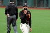 San Francisco Giants first base coach Alyssa Nakken reacts toward Oakland Athletics manager Bob Melvin during the teams' exhibition baseball game in San Francisco, Tuesday, July 21, 2020. (AP Photo/Jeff Chiu)