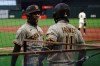 San Diego Padres' Trent Grisham, left, is congratulated by Ty France after scoring against the San Francisco Giants during the fourth inning of a baseball game in San Francisco, Thursday, July 30, 2020. (AP Photo/Jeff Chiu)
